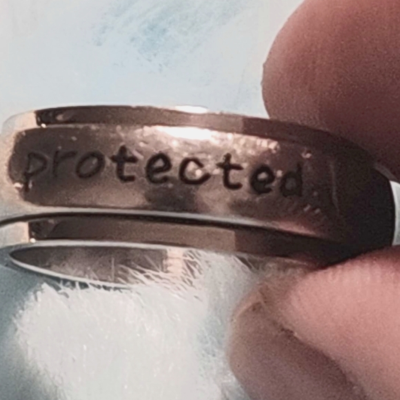 Ring, silver tone, reads "protected by an angel" in black, size 9 - Picture 1 of 7